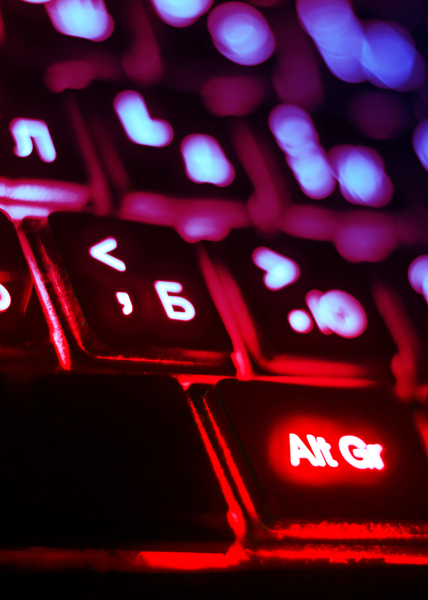 Luminous computer keyboard. Blue and red colour. Technologies, communications, the Internet, globalization